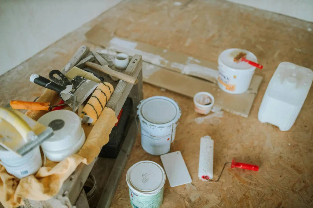 Overhead shot of tools and paint supplies for a home renovation project.